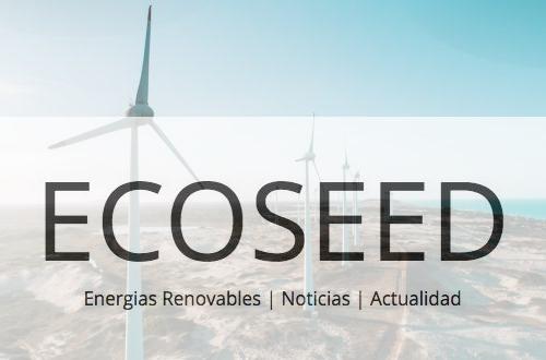 a row of wind turbines next to the ocean