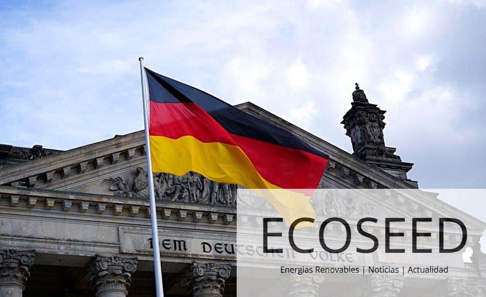 German national flag waving in front of the Reichstag building in Berlin, a symbol of democracy.
